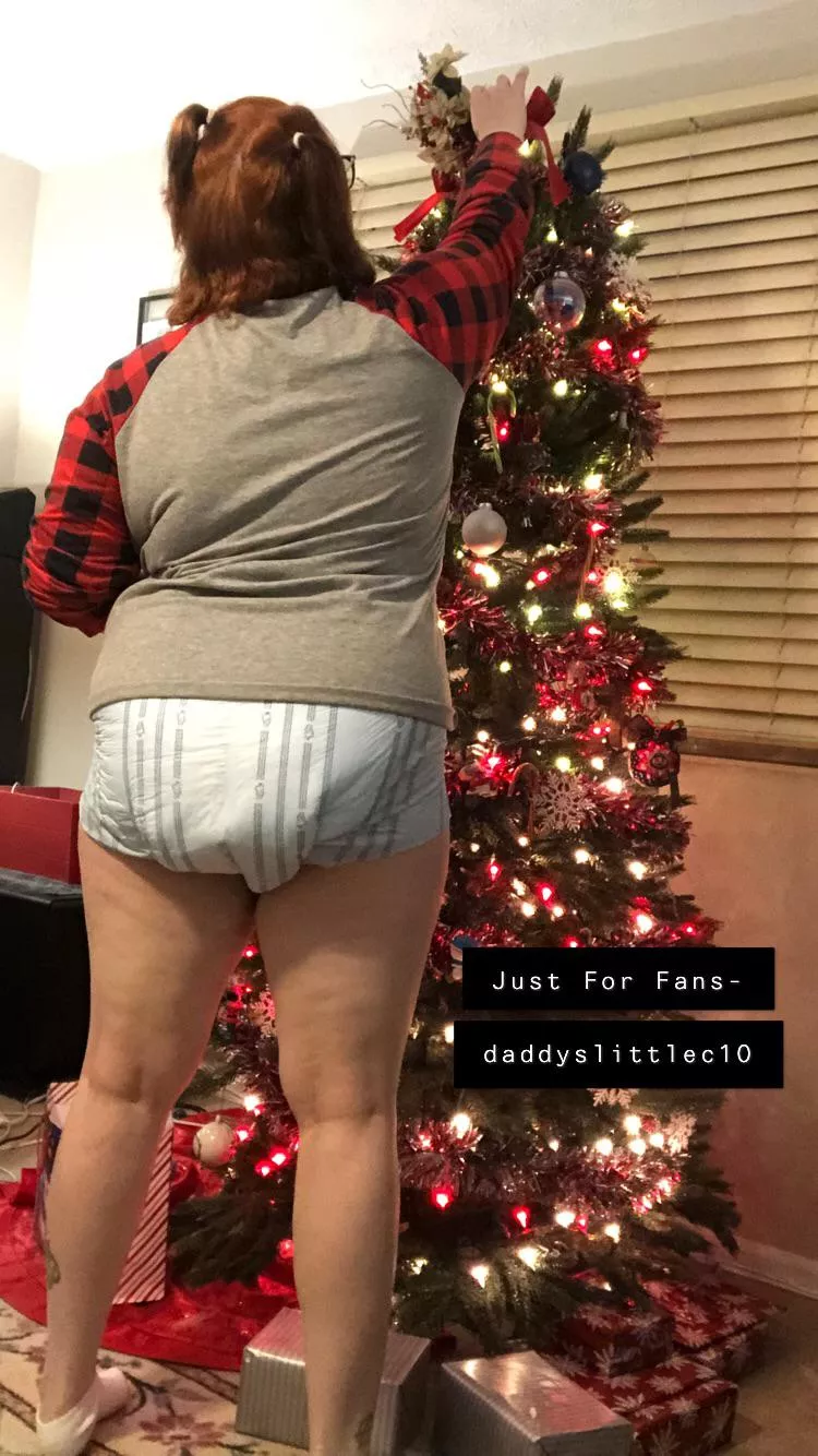 Baby putting the topper on the tree Baby putting the topper on the tree