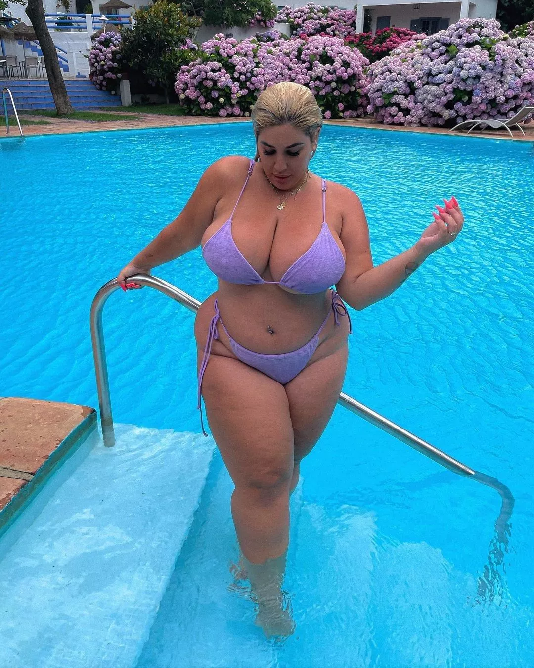 Even Natalia Lozano needs to sneak a peek at her massive melons