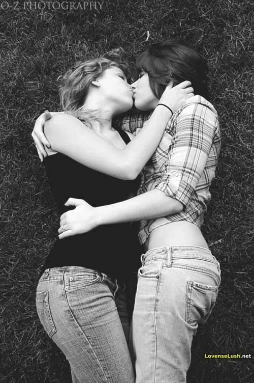 Girls kissing in the grass