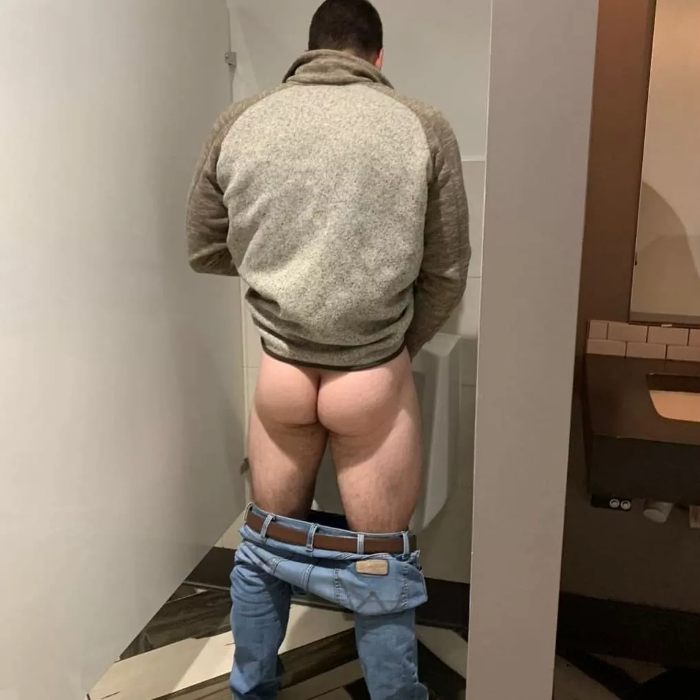 I always pull down my pants at the urinal. No one cares.