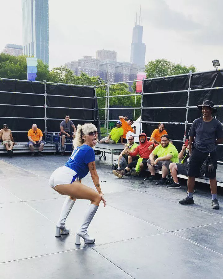 Miley giving stage crew a show.