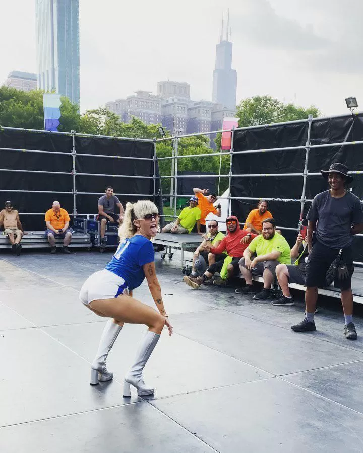 Miley giving stage crew a show.