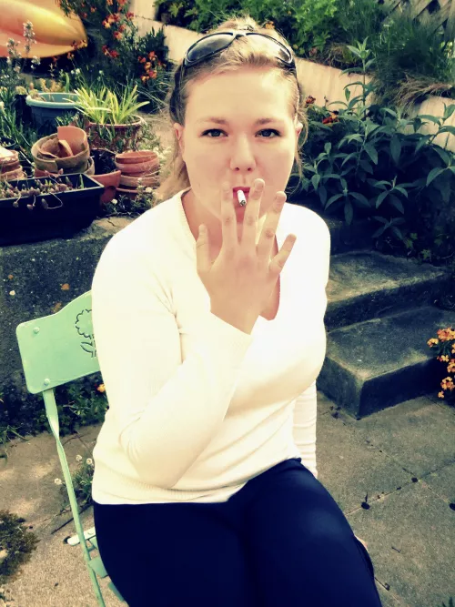 My girlfriend, dragging on her cigaretteβ¦