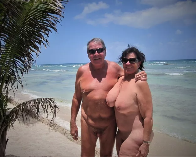 Nudist couple posing in a tropical paradise