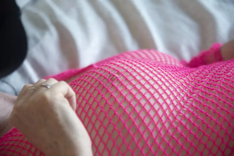 Pink fishnet and pink nipple.