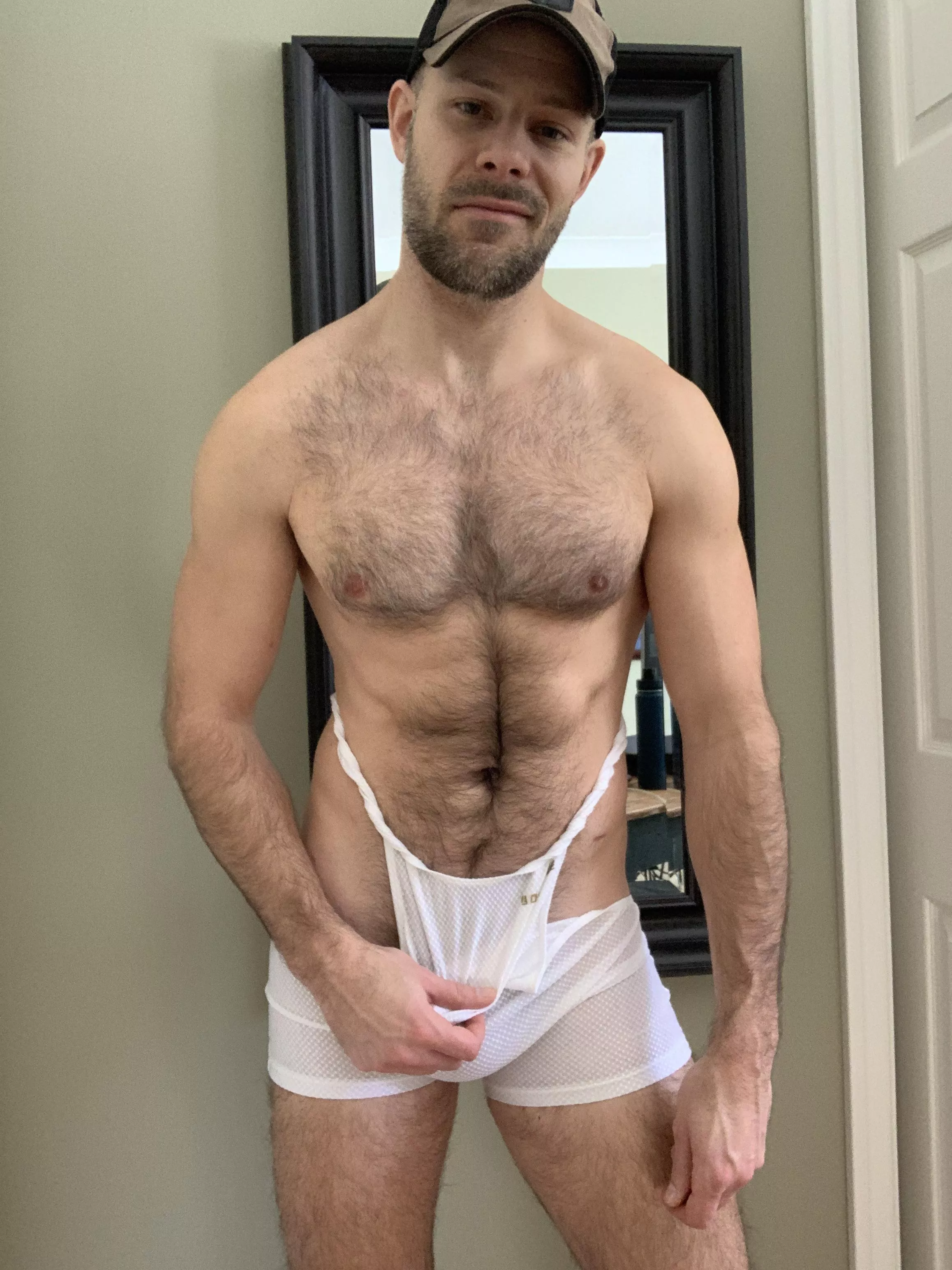 Pulling off my sweaty singlet.