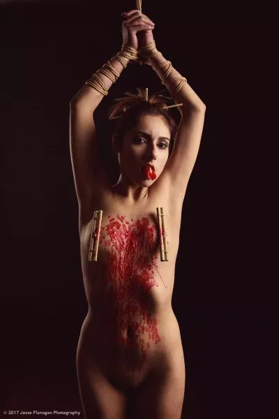 Self waxing while clamped and bound .... I'd say she's pretty busy right now !