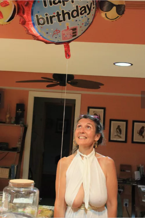 She looks at the balloon above, but the others look at another balloon...