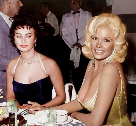 Sophia Loren gives Jayne Mansfield the side-eye. 👀 The photo, taken at a Paramount Pictures party to welcome Loren to Hollywood in 1957, was later colorized.