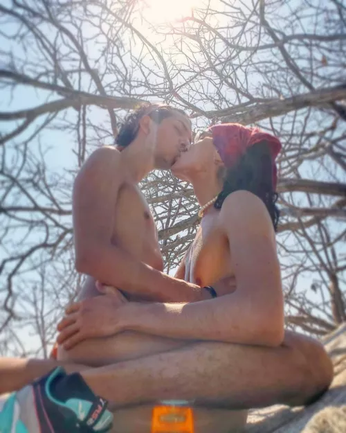 Two lovers on a rock by the beach...