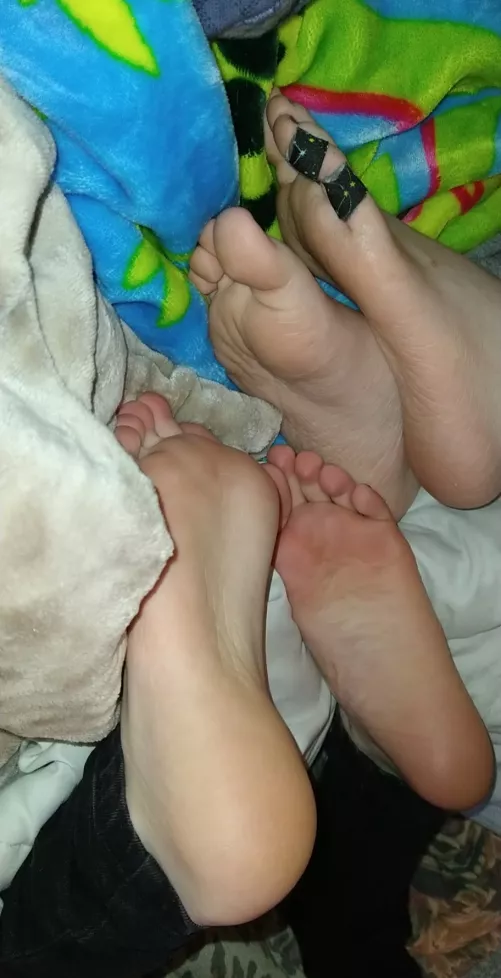 Two pairs of cute tomboy feet right in your face!