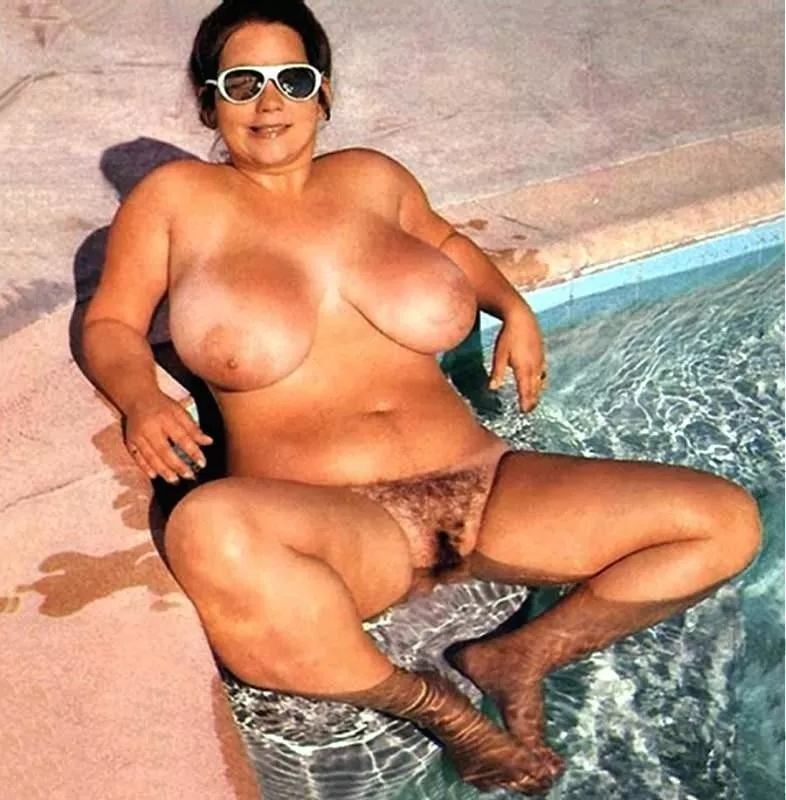 Vintage busty nudist relaxing in the pool