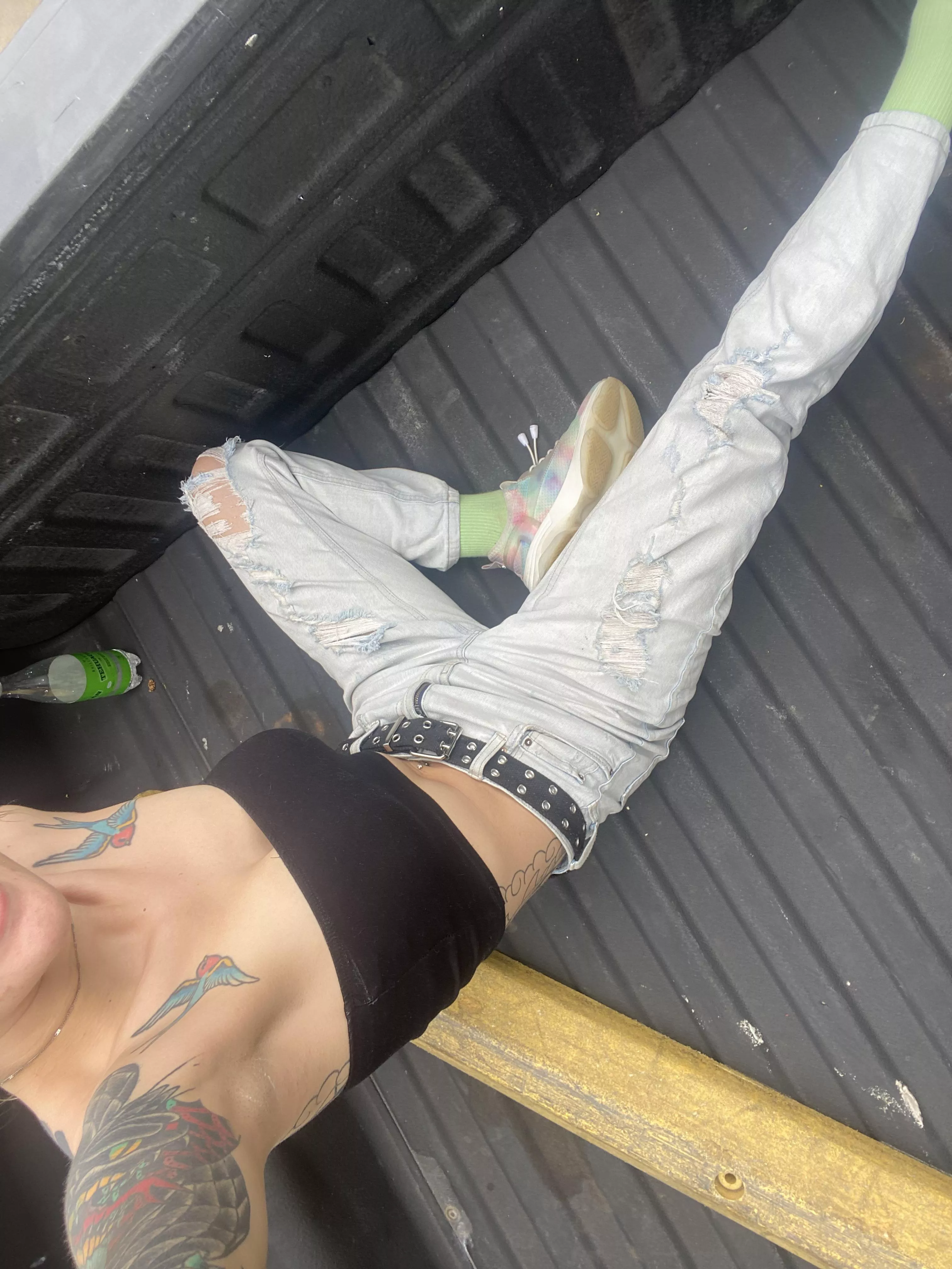 In the back of a pick up with a little piece of cloth hanging for dear life 😛😅😅