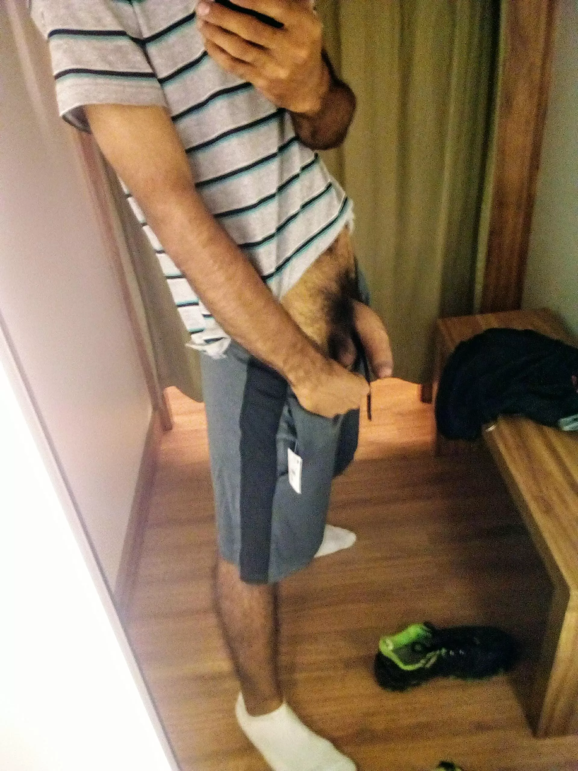 In the mirror of a store. I love grey sport shorts.