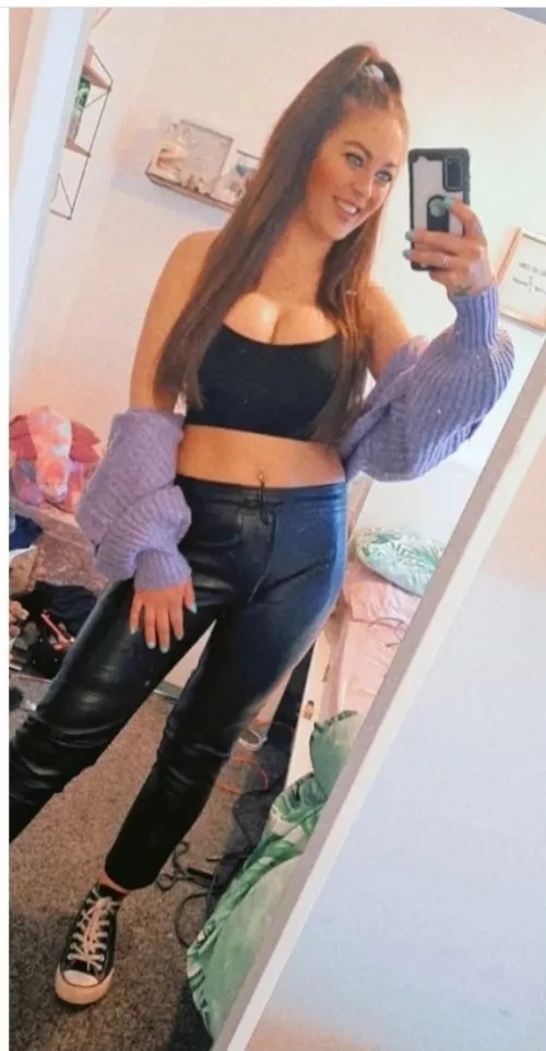 Leather trousers, messy room, tits out. Definite chav.