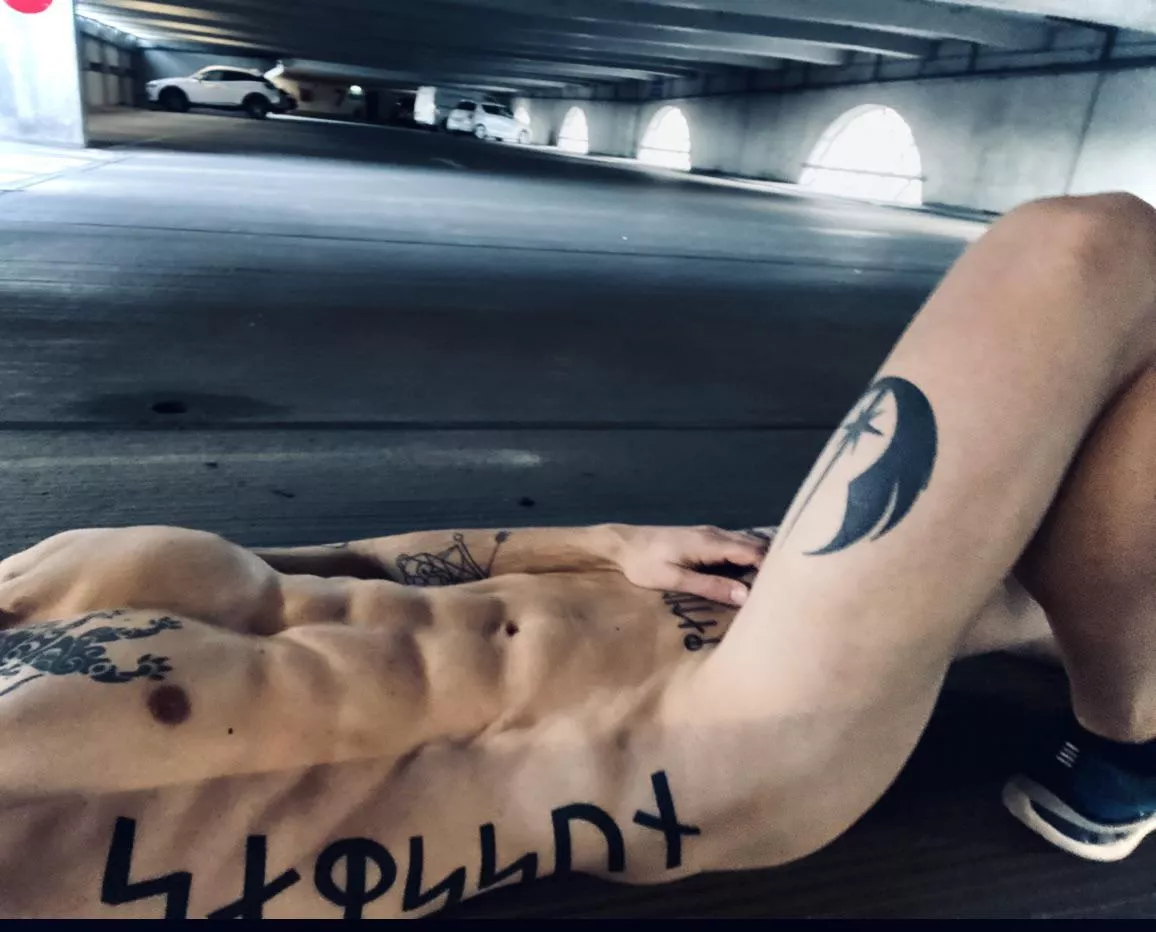 Lying naked in a car park. Sure i’m being watched