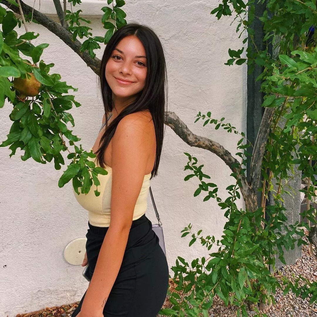 She’s trying to hide them behind a tree branch but she still can’t conceal them