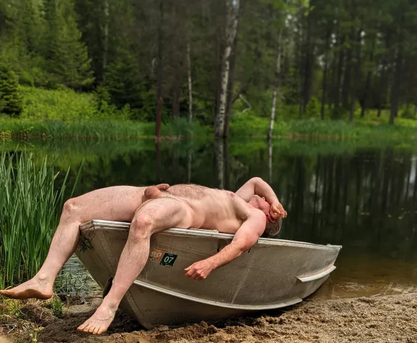 Sunning myself on a boat at the lake; if it's yours, I hope you don't mind