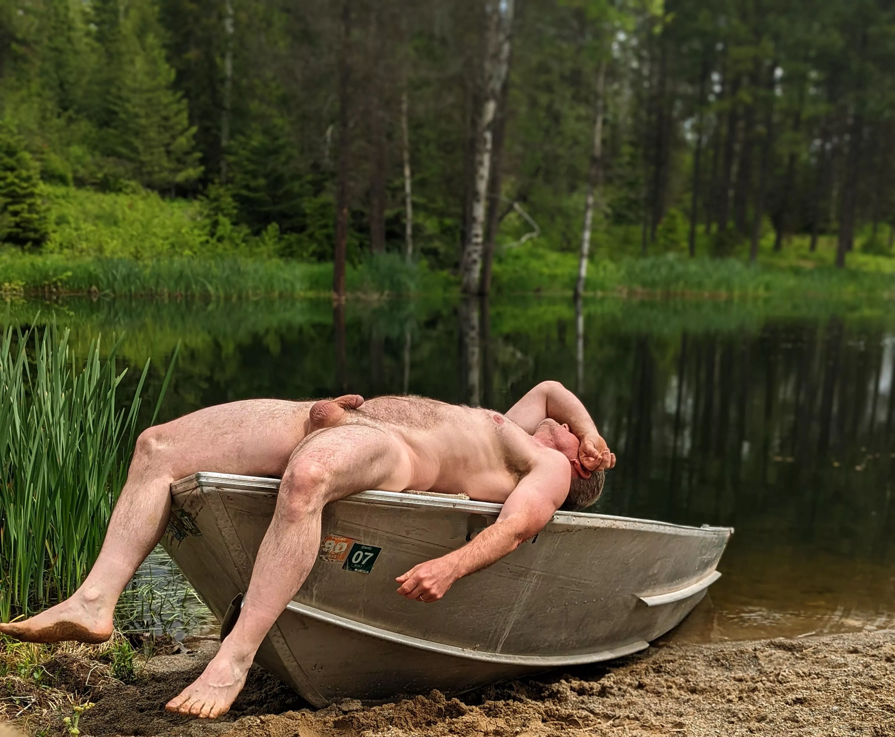 Sunning myself on a boat at the lake; if it's yours, I hope you don't mind