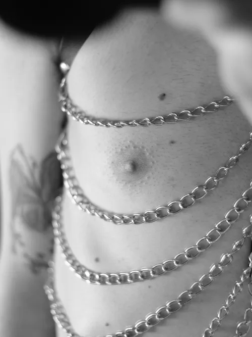 A close-up from my chest harness. I like how the chains fall and frame my button here 