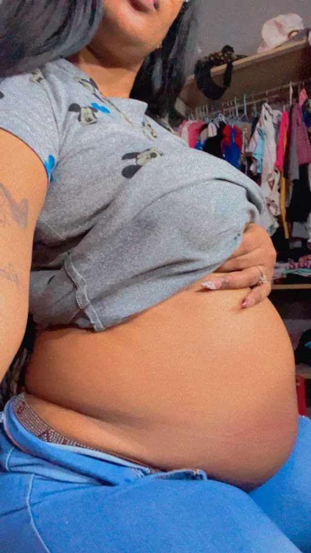 A Latina woman with a large, sagging belly.