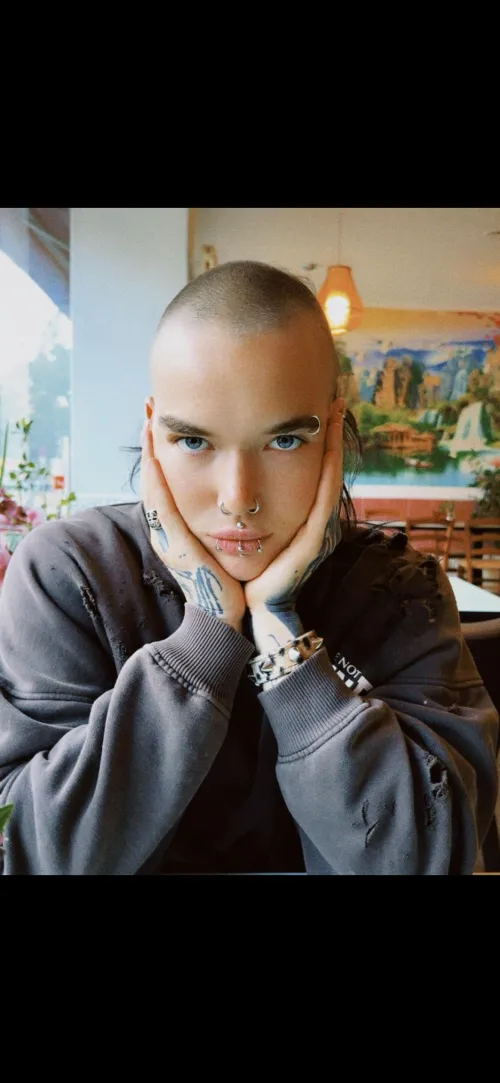 Androgynous, pierced and bald