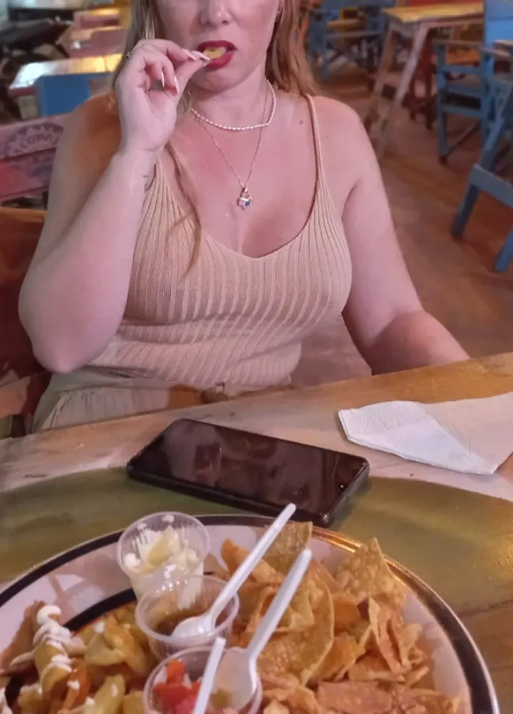 Eating some french fries, without a bra of course
