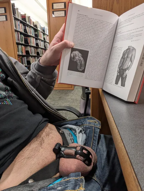 If you're going to take a caged pic in a library, you might as well do it with the book on dicks with a section on chastity