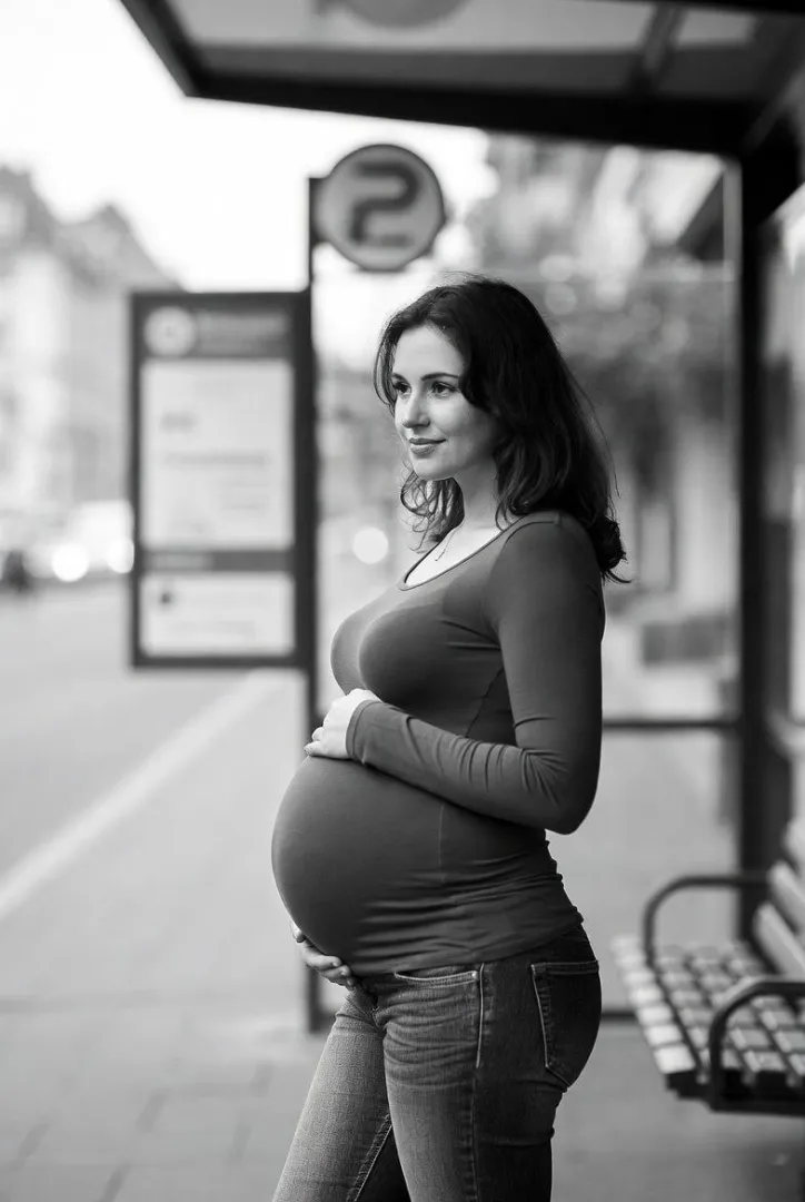 Pretty pregnant woman waiting for the bus