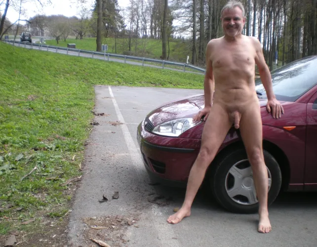 Standing with red car