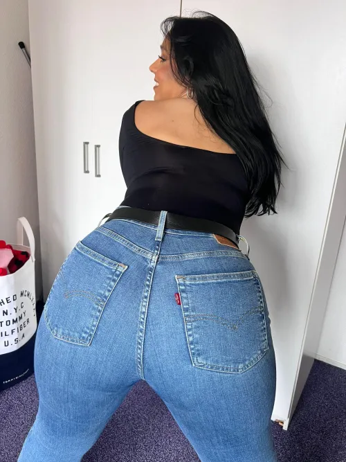 Tanned and tempting in Levis sparking sassy warmth the beachs most captivating allure