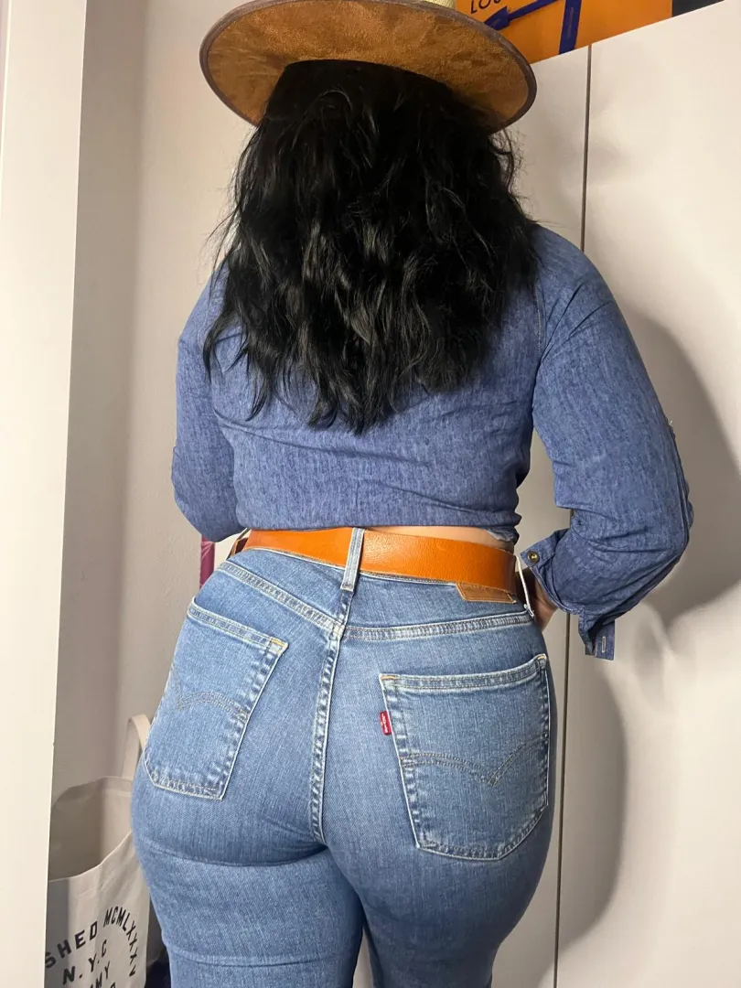 Tanned curves in Levis sparking playful heat the beachs most captivating star