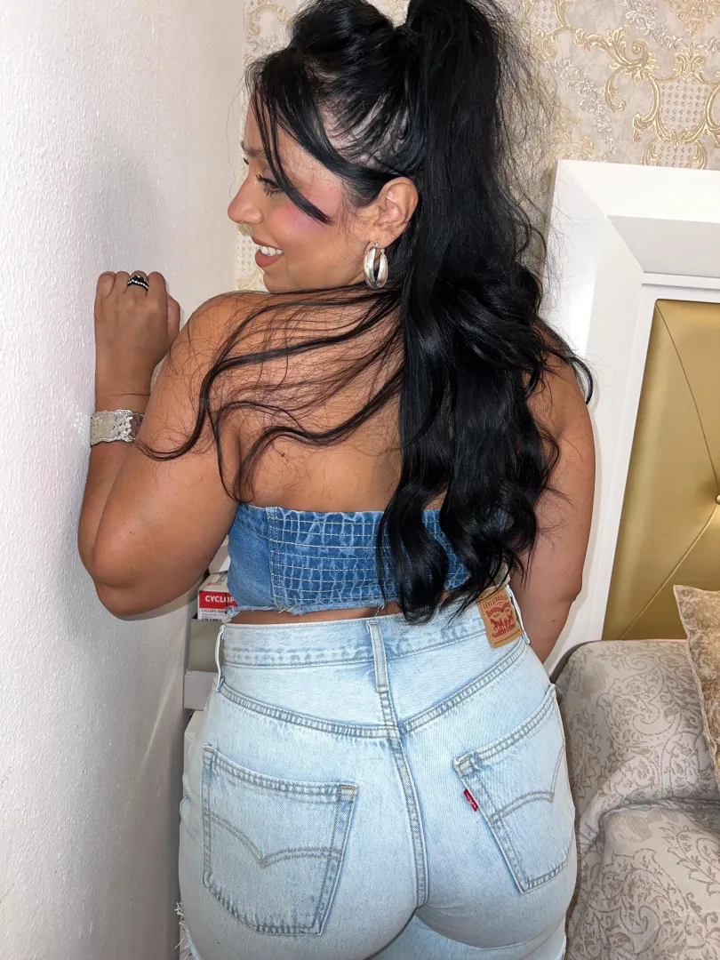 Tanned silhouette in fitted denim radiating bold heat summers sexiest seaside allure