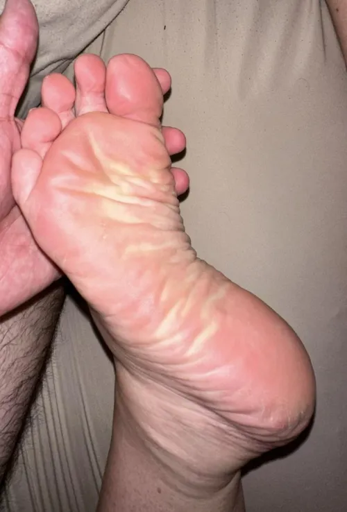 Tell me what you’re doing to my wife’s foot as I hold it up for yo
