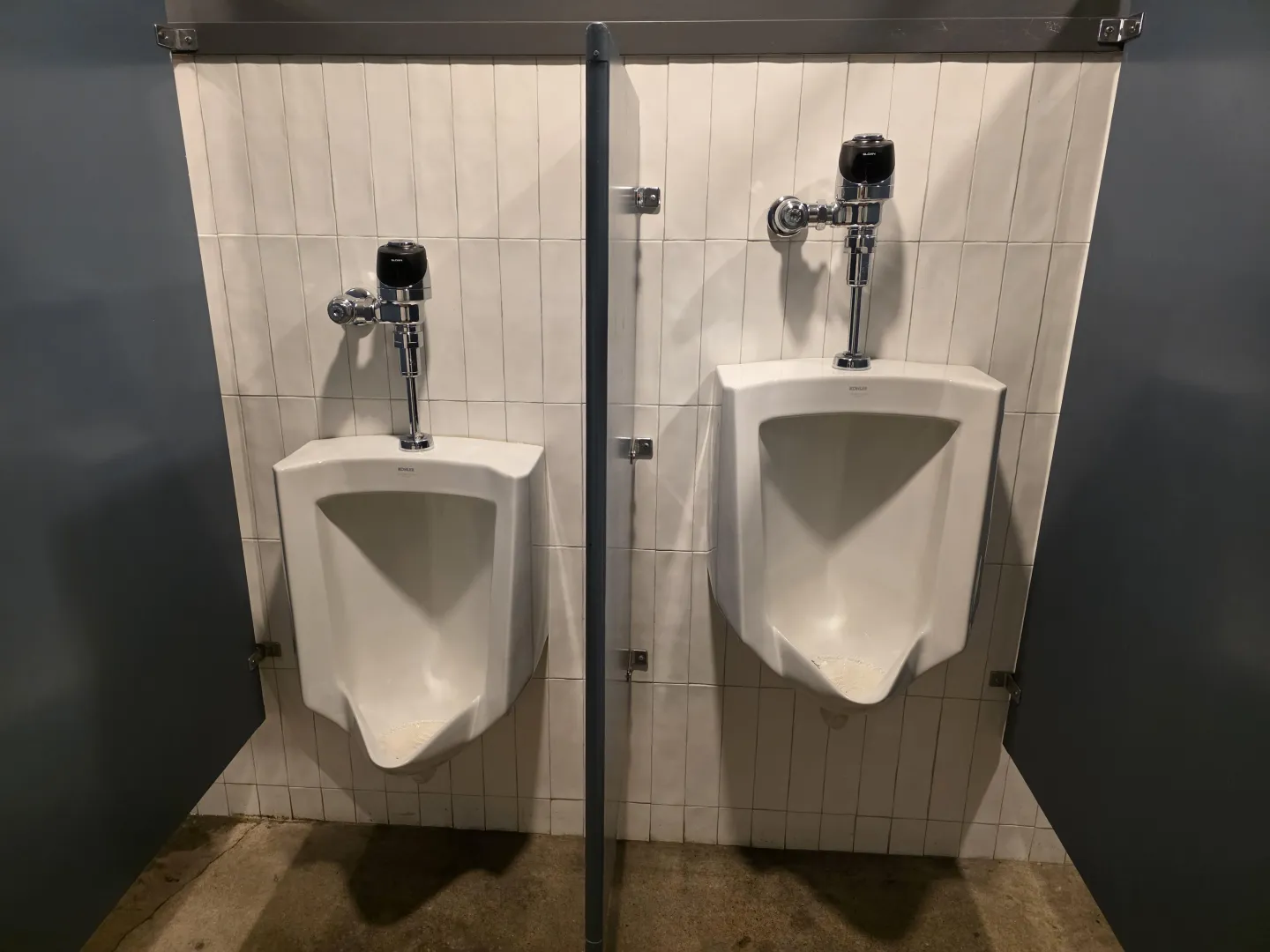 This partition between the two urinals was far too large.