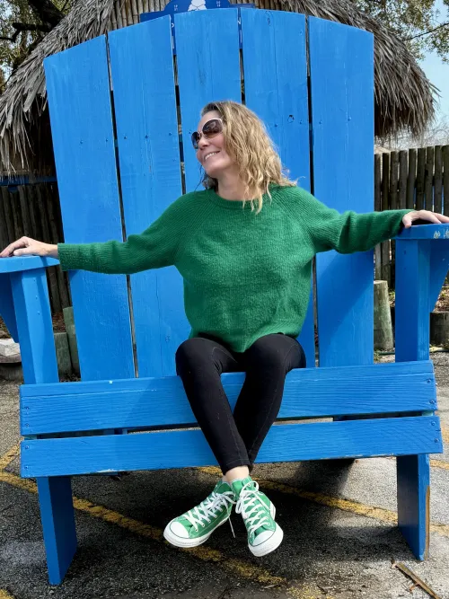 Wearing green chucks in a giant chair. 59yo