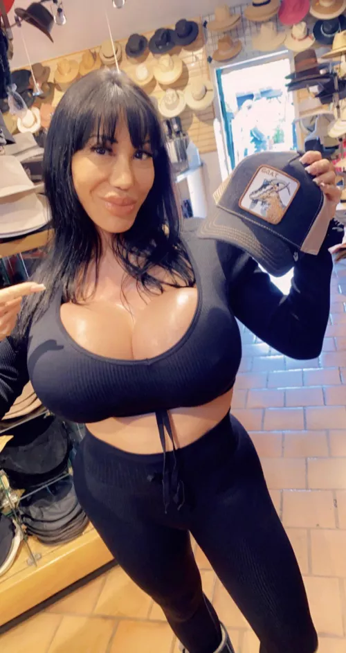 Walking through the gift shop with her fake knockers on full display!