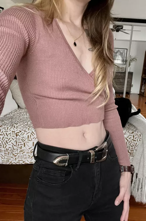 A cropped pink sweater