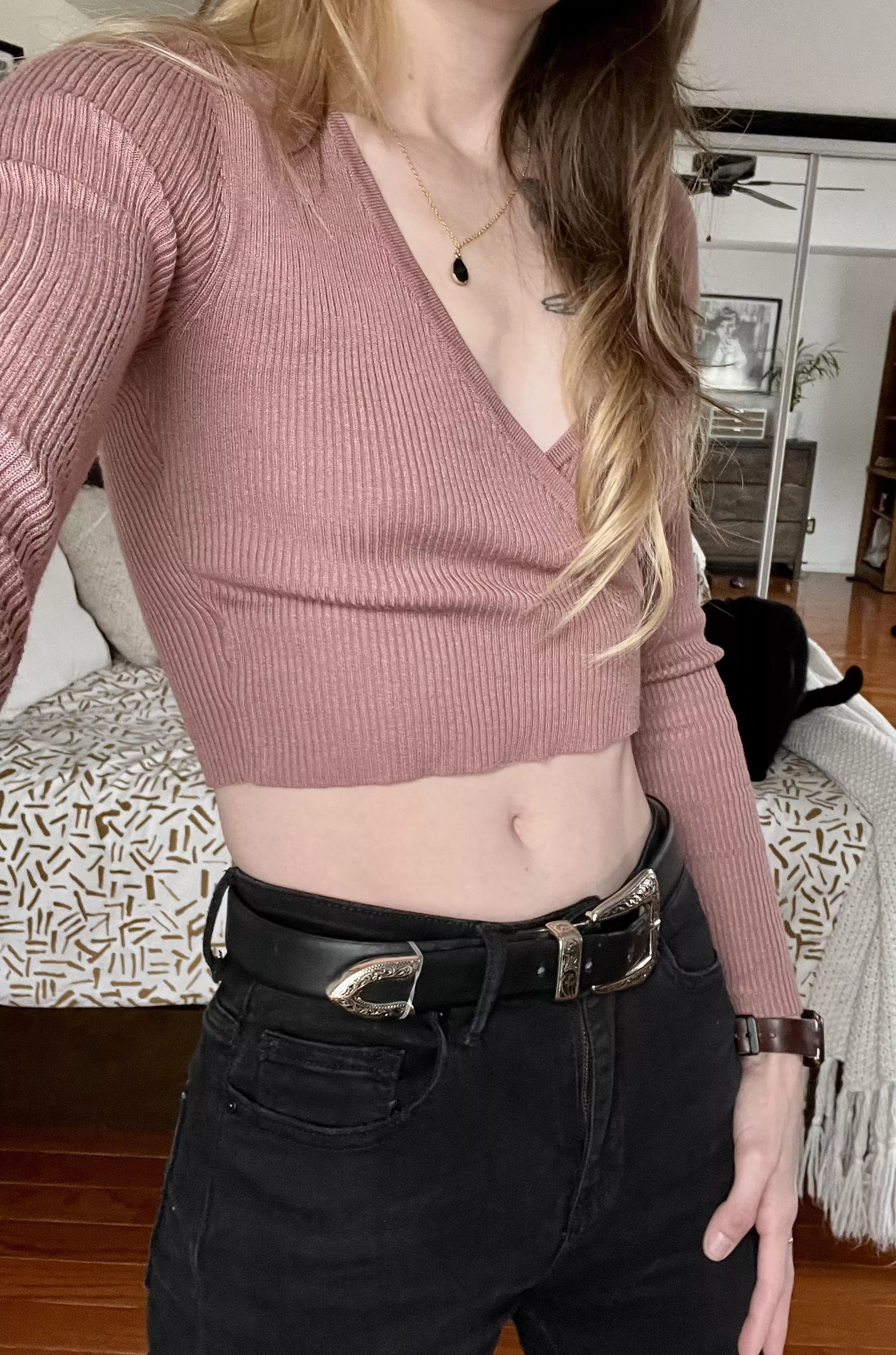 A cropped pink sweater
