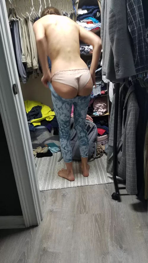 Trying to fit it in her gym pants