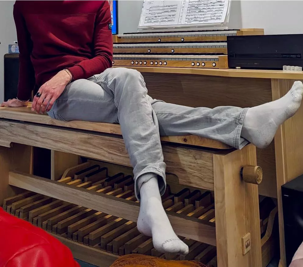 My feet on a wooden organ
