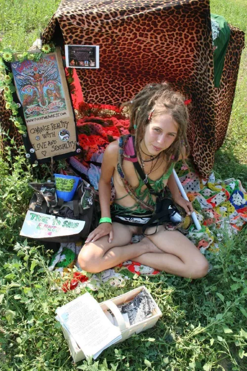 Leona, hippie Chick from fuck for forest selling something at a festival. nice dreads!
