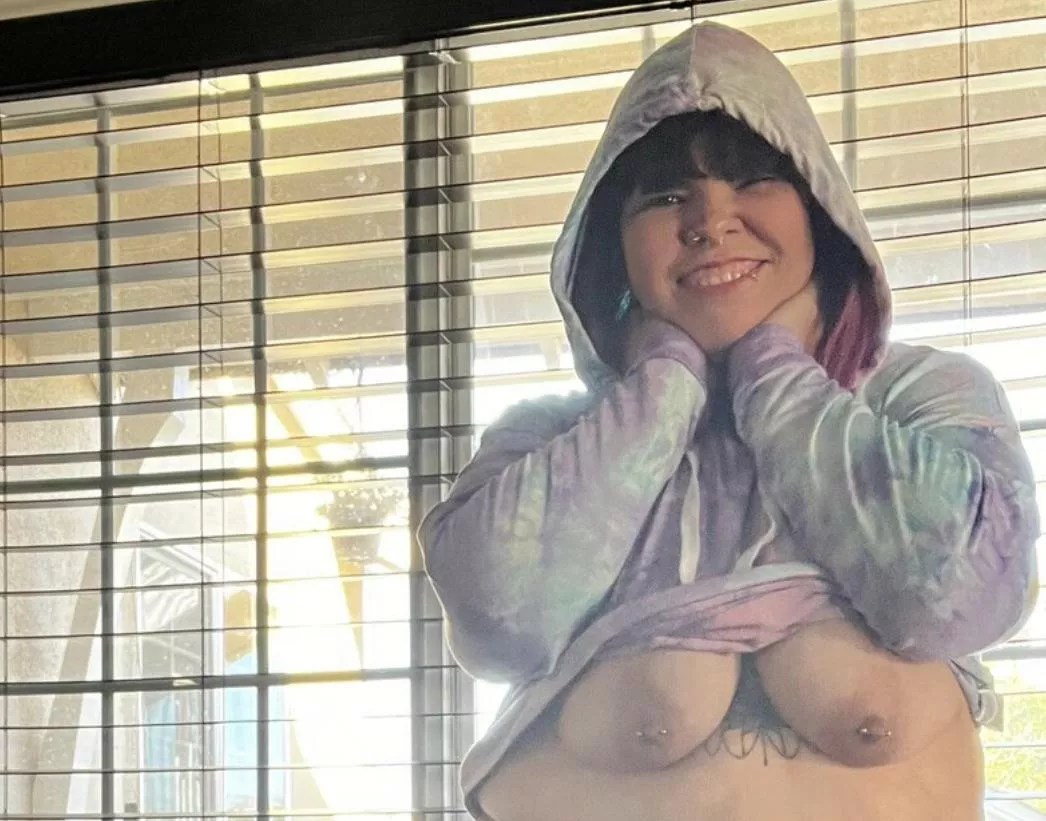 In front of the open blinds