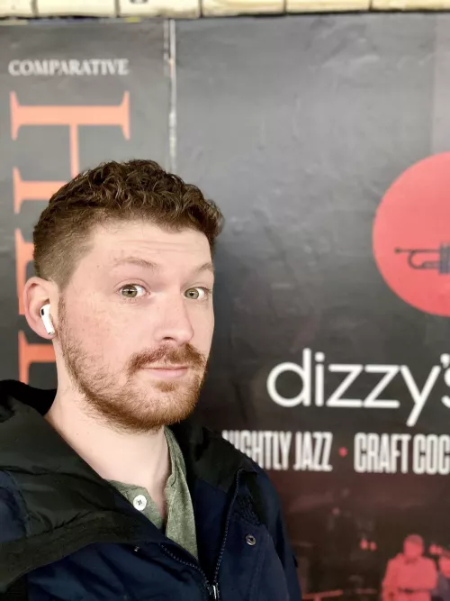 Latest Haircut in front of a sign that describes me all weekend