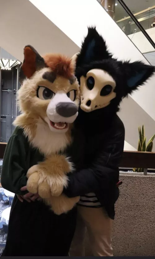 Me and my partner at a con after I converted him to become a furry