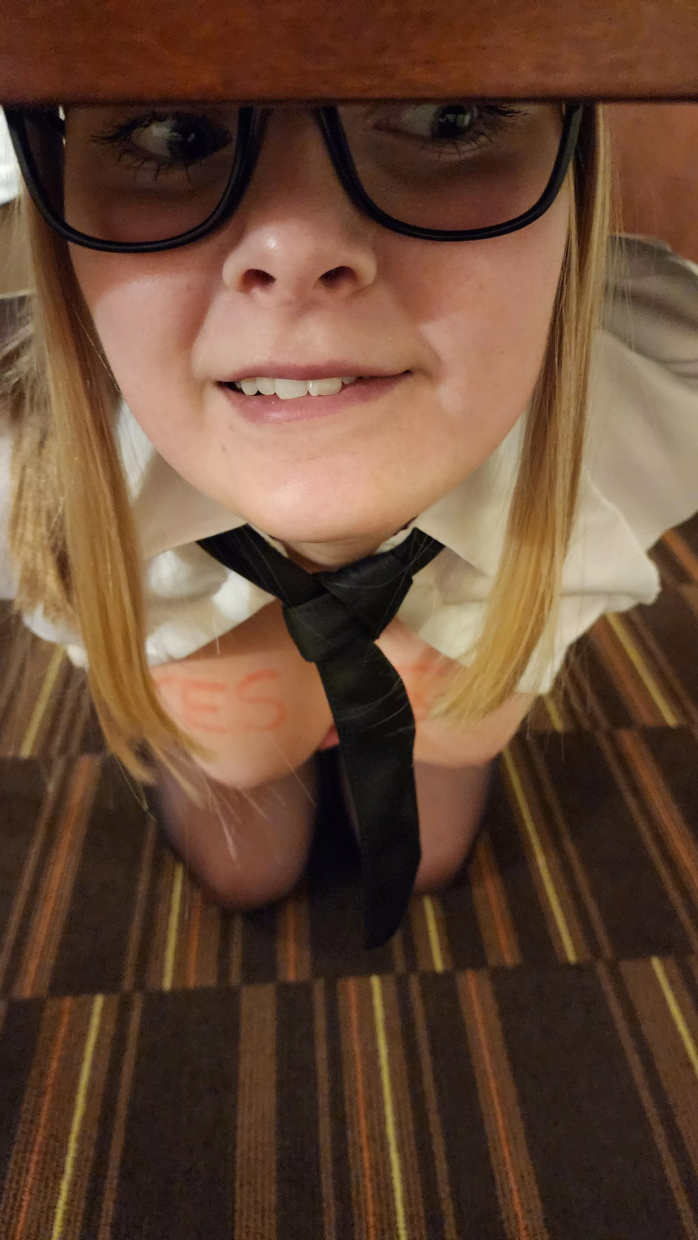 Can you read what this intern has written on her tits, sitting under your desk?