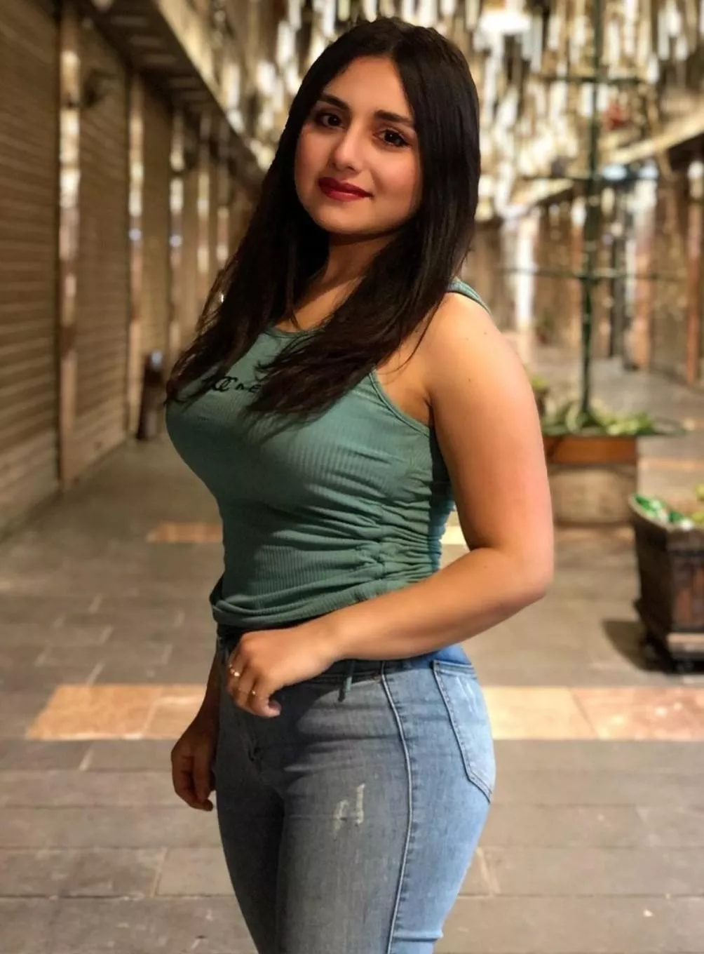 Brunette beauty in tank top & jeans