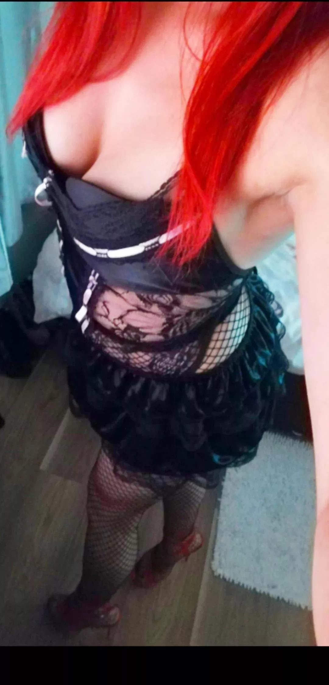 Redhead, red heels, fishnets and cleavage.