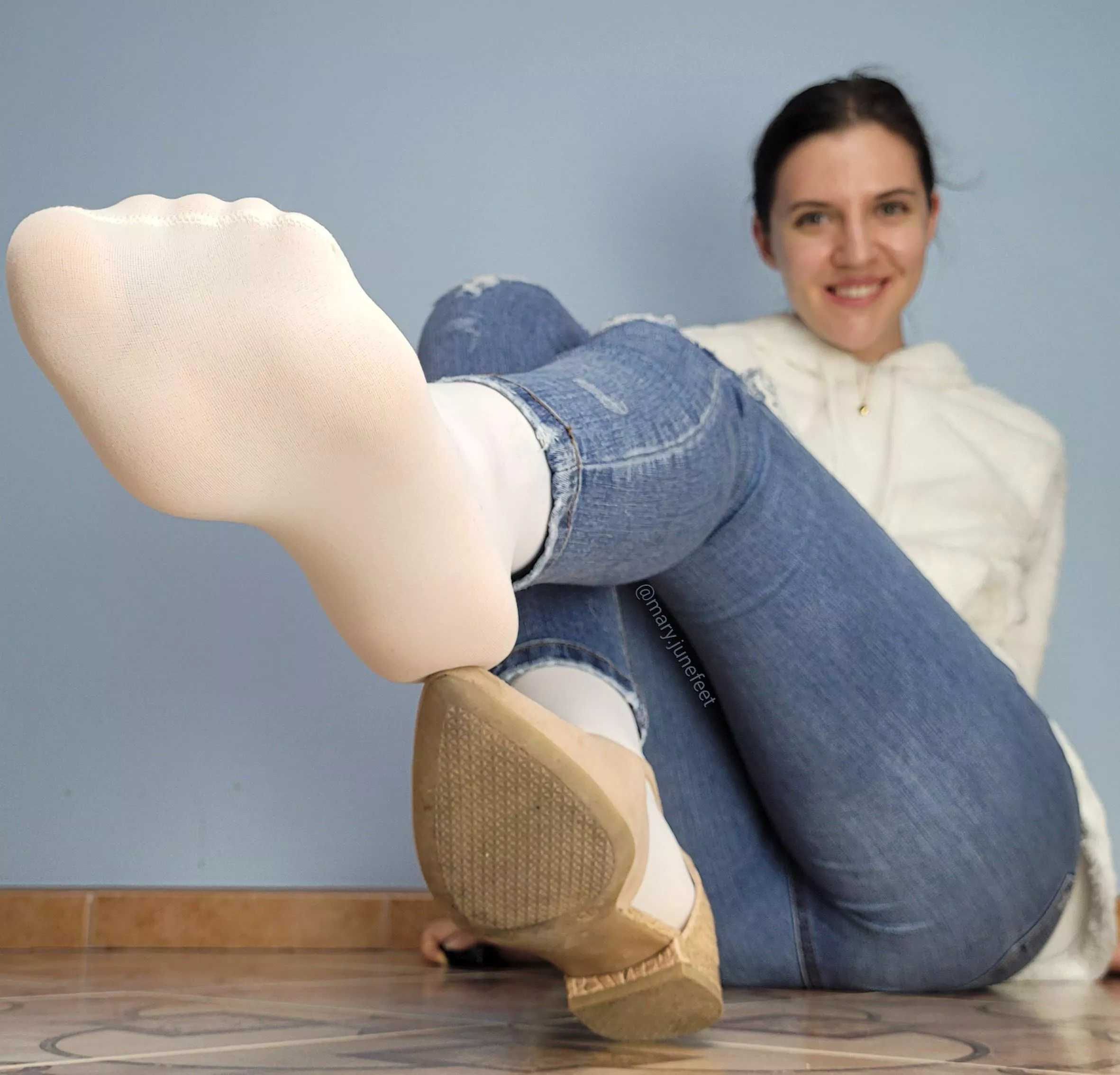 White pantyhose on my arched foot.