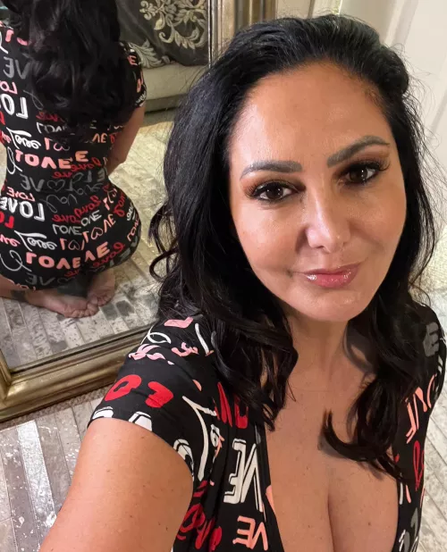 The mirror has her back